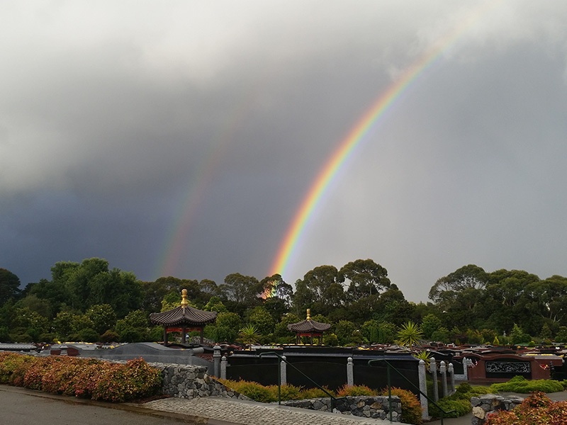 A Rainbow over Song He Yuan at Springvale Botanical Cemetery resembles hope emerging through a dark storm.