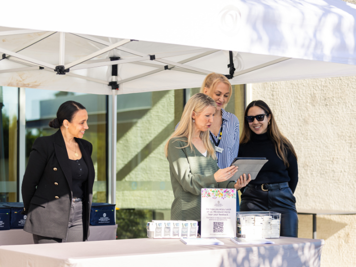 A photograph of the team at Bunurong Memorial Park standing behind a table, preparing to welcome guests to collect their picnic hampers.