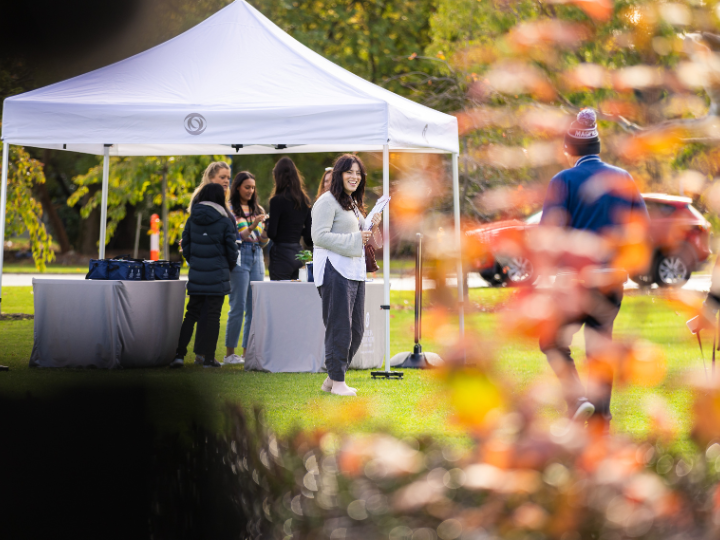 A photograph of the team at Springvale Botanical Cemetery, greeting community members as they approach the marquee to collect their picnic hampers.