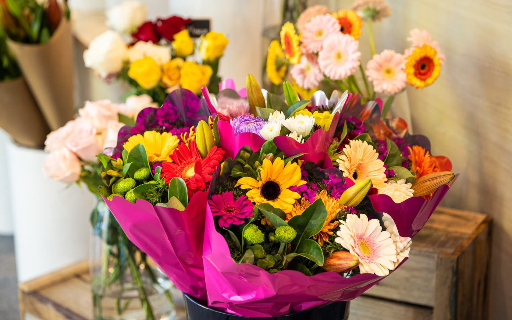 Assorted flower bouquets and floral arrangement options displayed in the SMCT florist, featuring roses, lilies, and seasonal blooms